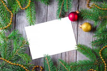 Fototapeta na wymiar Empty clean sheet of paper for your text and christmas fir tree on wooden background, top view. Christmas background