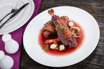 a chicken rooster stewed in red wine