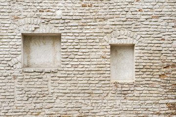 abandoned grunge cracked brick stucco wall with a stucco frame