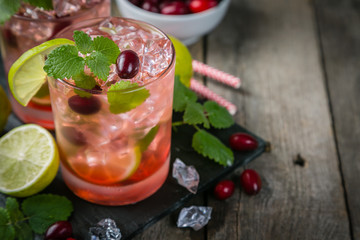 Cranberry mojito on rustic wood background