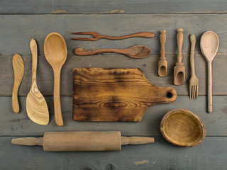 wooden kitchen accessories on a wooden background. 