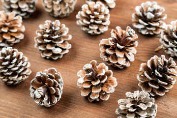 Dry fir tree cones on a wooden table, closeup