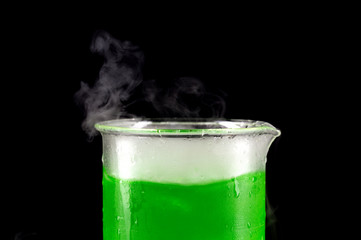 sublimation of dry ice in beaker with green liquid
