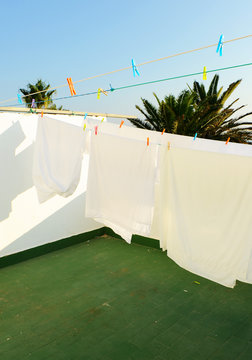 White sheets on the terrace clothesline