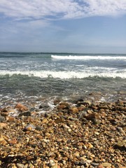 Fototapeta na wymiar Rocky beach with incoming waves