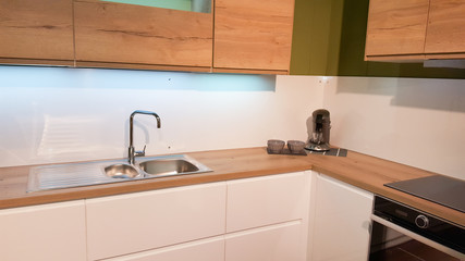 Fototapeta na wymiar The interior of the modern kitchen in wood and white