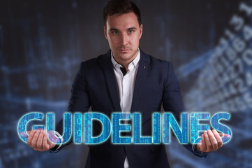 The concept of business, technology, the Internet and the network. Young businessman showing inscription: Guidelines