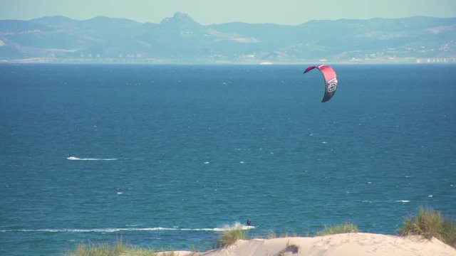 Kitesurfers surfing in the coast of spain near to africa