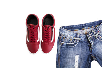 Fashion shoes with shoes. Red sneakers and laces with jeans on a white background