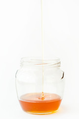 Pouring Pure Honey into Glass Jar