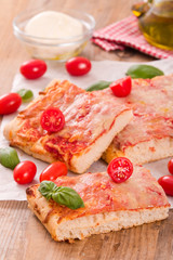 Fototapeta na wymiar Italian pizza with cheese, tomatoes and fresh basil. 