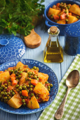 Vegetarian food - potatoes with pea and tomatoes, greek style cuisine.