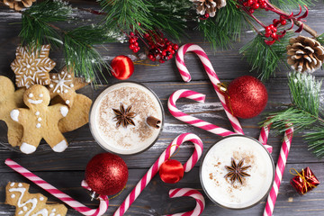 Glass of eggnog on wooden background