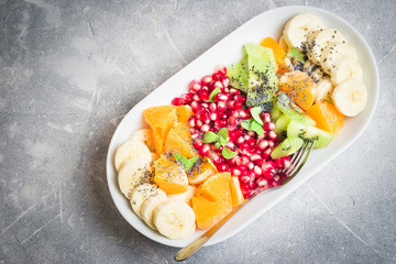 Honey mint  fruit salad on stone, concrete background. Top view, copy space