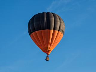  globo aerostático naranja y negro sobre cielo azul