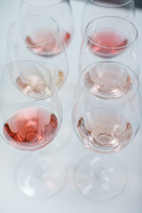 Row of glasses with white and rose wines prepared for tasting