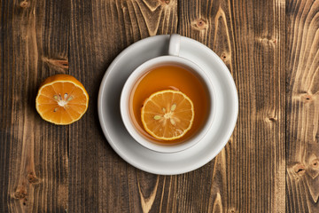 Hot beverage with sugar cubes on wooden background