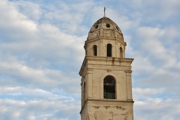 Bell tower and cloudy blue sky in Sirolo, Italy