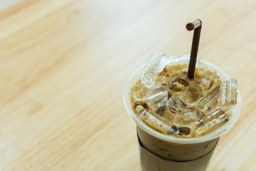 Iced coffee in glass on wood table