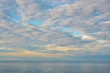 Infinite blue cloudy sky over the sea, Italy