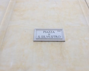 Piazza di San Silvestro street name sign, square between Piazza San Claudio and Via delle Mercede, in Rome, Italy, in the Trevi and Column districts