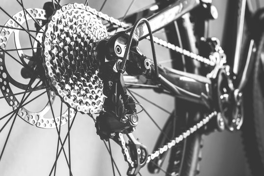 Bicycle details black and white frame, rear wheel mountain bike gear from view