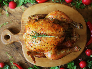 Whole roasted chicken on cutting board