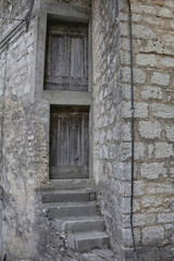 Fototapeta na wymiar An old wooden door in a derelict building the historic hill village of Erto in Friuli Venezia Giulia, north east Italy 
