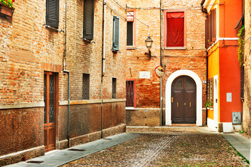 Fototapeta na wymiar Ferrara, Italy - 22.06.2017: The streets of the historic Italian city of Ferrara, typical Italian houses