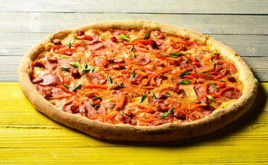 Fast food restaurant. Pizza with bacon, sausages and green onion