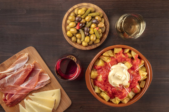 Tapas and wine. Patatas bravas, olives, jamon, cheese