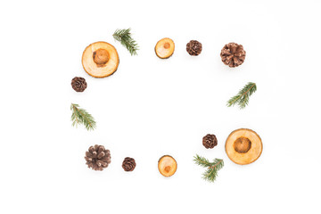 Christmas wood slice decorations, pine cone, spruce branches on white background, flat lay, top view, copy space