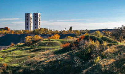 Landscape with two mine head frames . Ukraine, Kryvyi Rih, Iron-ore mine Gvardeiskaya. An autumn sunny day with blue sky. Mining