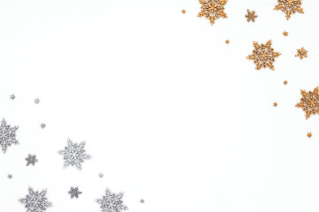 Golden and silver christmas snowflake on white background, flat lay, top view, christmas pattern