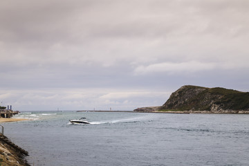 Fototapeta na wymiar small outboard speedboat entering fast in the sea port 