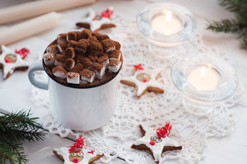 Christmas composition. Winter hot drink.  hot chocolate or cocoa with marshmallow on white background with decorations candles, cookieas or ginger bread. Christmas, winter and holiday concept.
