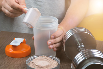 Sports, fitness, man preparing a protein shake in a shaker