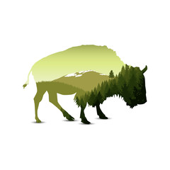 Silhouette of bison with green panorama of mountains. © yik2007
