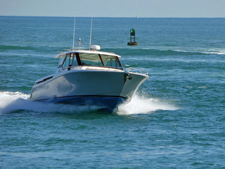 Fototapeta premium Fishing boat returning to port entering Government Cut in Miami