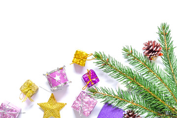 Branch of a Christmas tree with balls, fir cones, traditional candies and boxes with gifts isolated on white background.Christmas and New Year background.