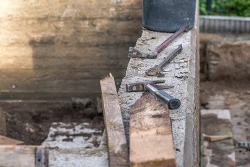 Worker with a crowbar when stripping a wood-clad concrete wall