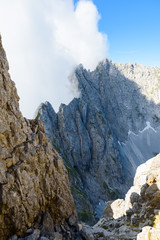 Mountains in clouds at Ellmauer Halt, Wilder Kaiser mountains of Austria - close to Gruttenhuette, Going, Tyrol, Austria - Hiking in the Alps of Europe