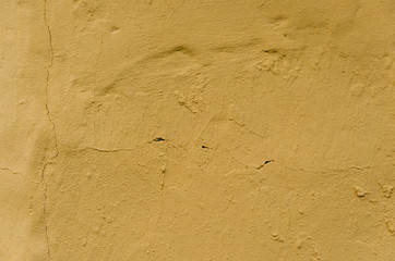 Fototapeta na wymiar Abstract background of cracked yellow paint 