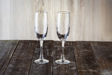 A couple of empty glasses on a wooden background