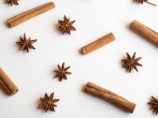 Cinnamon sticks spice stars on a white background lying Flat lay