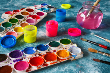 Gouache paints and art brushes for the artist with a copy space
