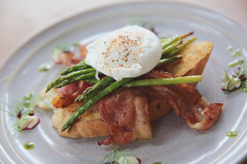 eggs benedict poached egg on bacon asparagus and bread breakfast