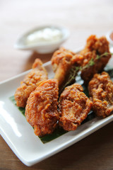Buffalo wings barbecue chicken with carrots  and cucumbers on wood background