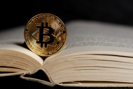 Gold bitcoin - popular cryptocurrency on open book page