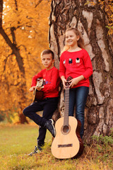 Guy with a girl in the park with a guitar